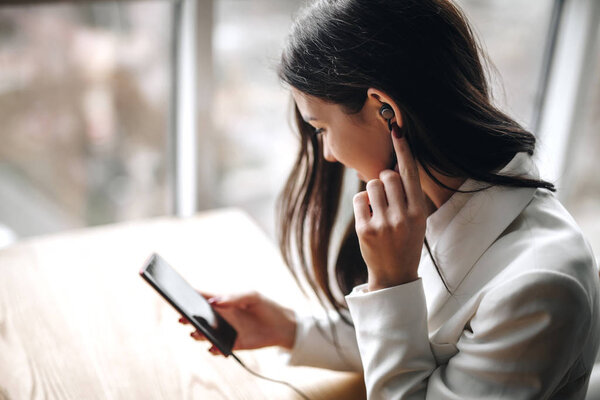 girl enjoy music in the office through headphones