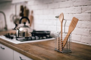 Ahşap mutfak aletleri tezgahın üzerinde duruyor.