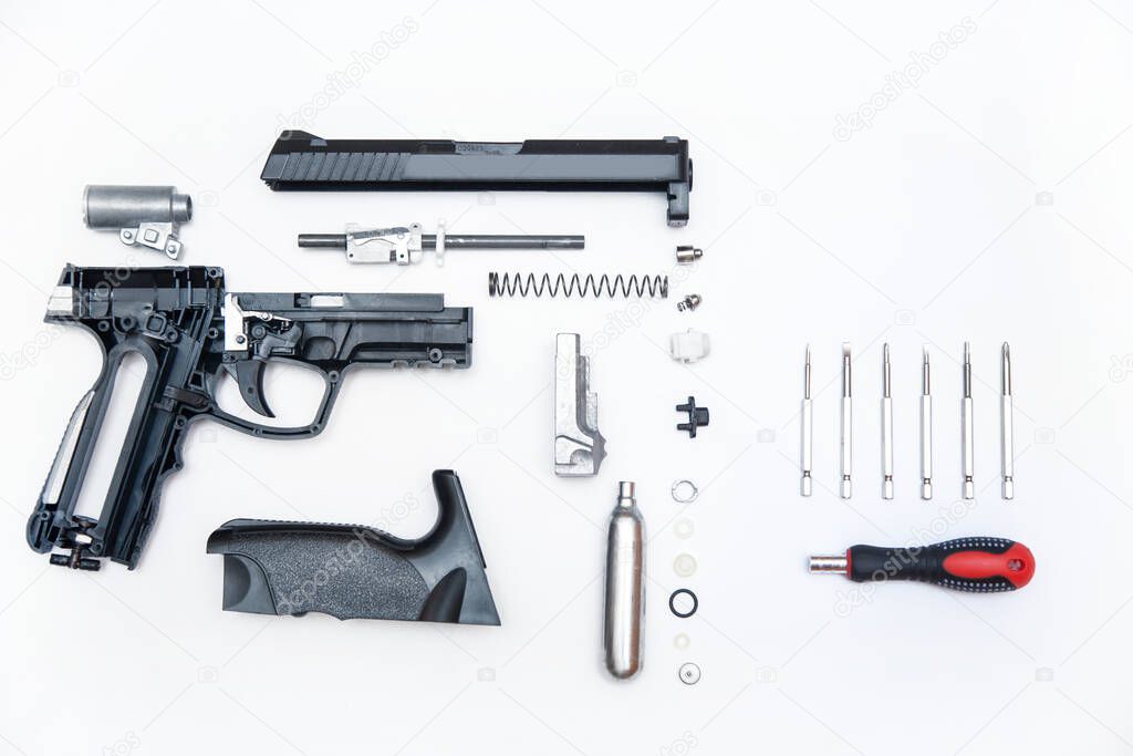 details of the gun neatly folded on a white background with a screwdriver