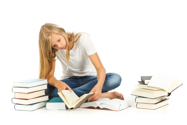 Jovencita sentada en el suelo leyendo sobre fondo blanco —  Fotos de Stock