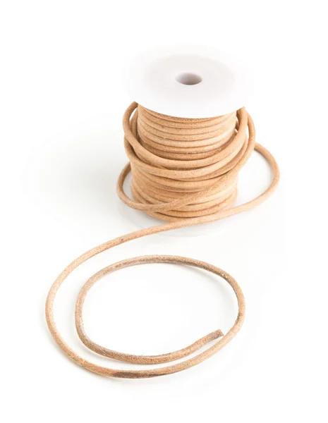 Brown leather cord on plastic spool — Stock Photo, Image