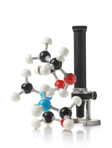 Modèle de molécule chimique avec vieux microscope sur fond blanc — Photo