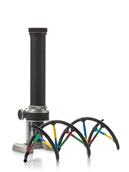 DNA molecule model with old microscope over white background — Stock Photo, Image