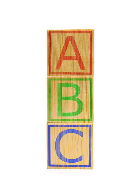 Empilhados de madeira marrom ABC cubos carta — Fotografia de Stock
