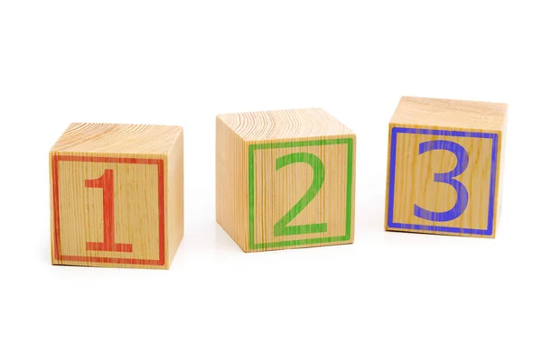 Three brown wooden cubes lined up in a row with numbers one, two Stock Image