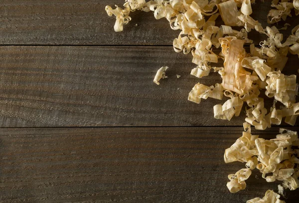 Light brown wood shavings from carpenter's hand planer or chisel — Stock Photo, Image