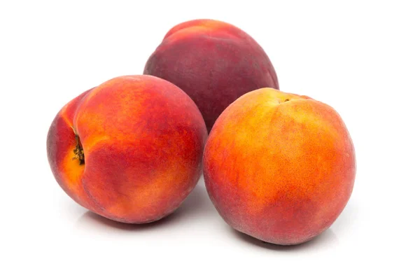 Three uncut, whole, ripe peaches fruit — Stock Photo, Image