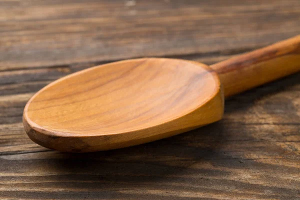 Wooden cooking spoon on wood board or table — Stock Photo, Image