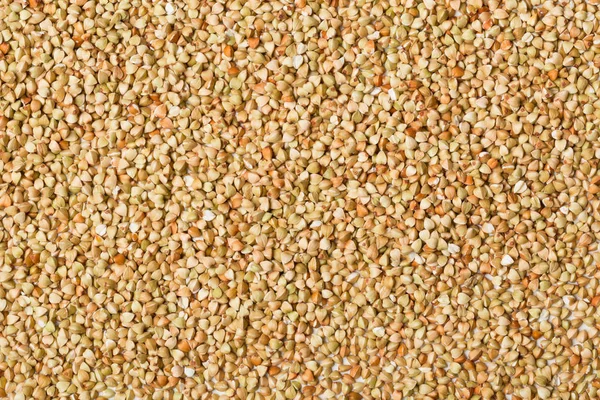 Background of raw, uncooked buckwheat kernels — Stock Photo, Image