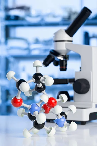 Microscope with molecule model in lab — Stock Photo, Image