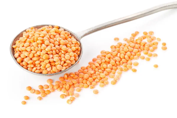 Raw red, dried  lentils in metal spoon — Stock Photo, Image