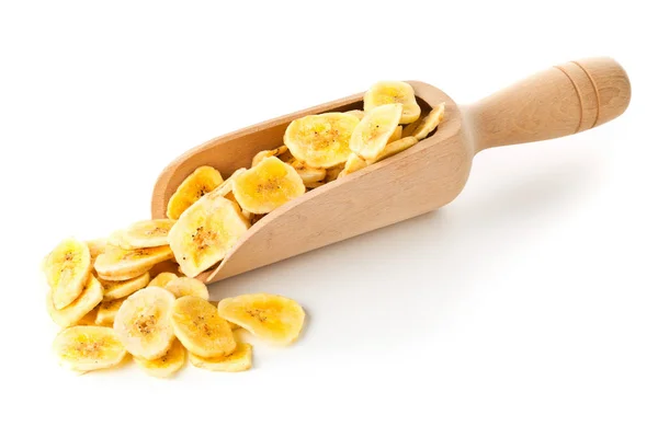 Heap of dried banana chips snack in wooden scoop over white — Stock Photo, Image