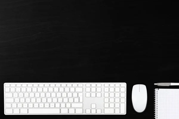 Černý dřevěný office desk pohled shora s počítačovou myš, klávesnice, — Stock fotografie