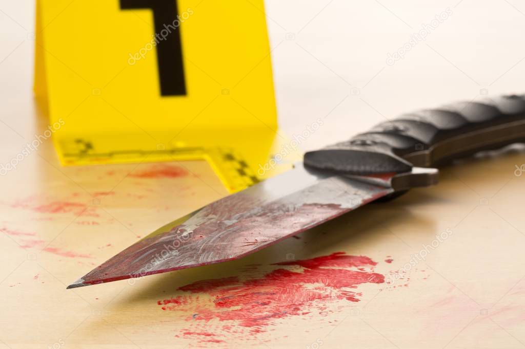 Crime scene investigation CSI evidence marker with bloody knife 