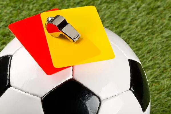 Close up of referee yellow and red cards and chrome whistle