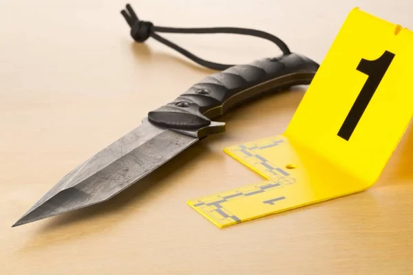 Crime scene investigation CSI evidence marker with knife on wooden floor background at crime scene - police, evidence or forensic investigation concept — 스톡 사진