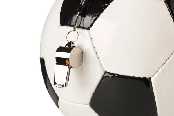 Single black and white soccer sports ball with referee whistle close up with selective focus over white — 스톡 사진