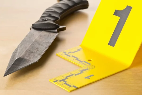 Crime scene investigation CSI evidence marker with knife on wooden floor background at crime scene — Stock Photo, Image