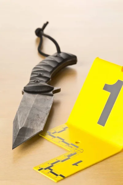 Crime scene investigation CSI evidence marker with knife on wooden floor background at crime scene — Stock Photo, Image