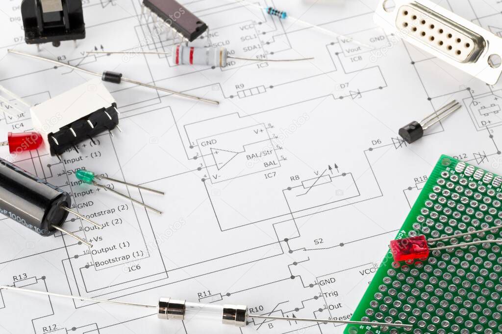 Different electronic parts or components on pcb wiring diagram background with resistors, capacitors, diode and ic chips, with copy space, selective focus