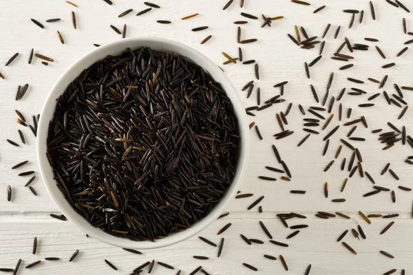 Heap Uncooked Raw Black Wild Rice Grains White Bowl White — Stock Photo, Image