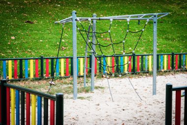 metal structure with chains for climbing in playground