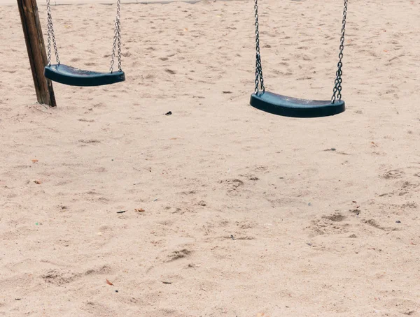 Swings hanging on chains in the playground — Φωτογραφία Αρχείου