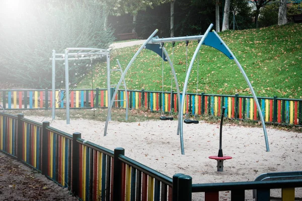 Slide and swings in the city park — Stock Photo, Image