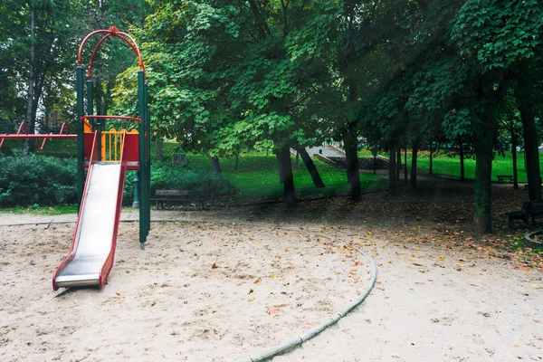 Slide and swings in the city park Stock Image