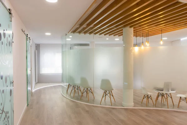 white waiting room lit with empty chairs