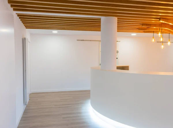 Reception of modern office with lights and wood on the ceiling