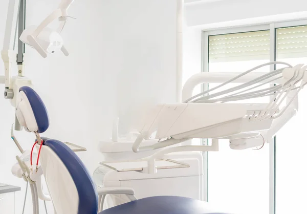Blue dentist armchair with instruments in white cabinet — Stock Photo, Image