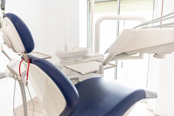 Blue dentist armchair with instruments in white cabinet — Stock Photo, Image