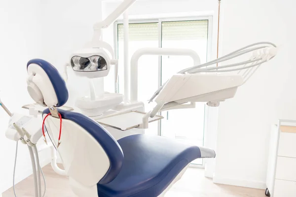 Blue dentist armchair with instruments in white cabinet — Stock Photo, Image