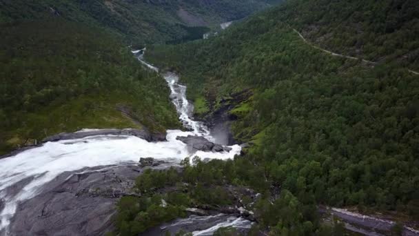 Waterfall in mountains of Norway in rainy weather from air view from drone — Stock Video