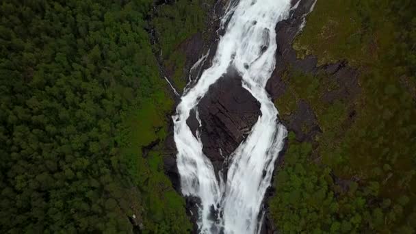 Waterfall in mountains of Norway in rainy weather from air view from drone — Stock Video