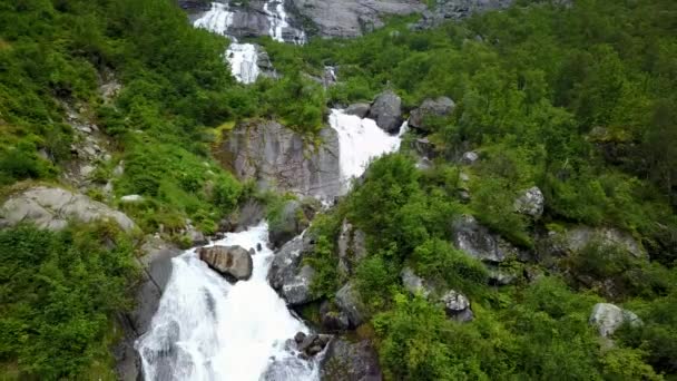 Waterfall in mountains of Norway in rainy weather from air view from drone — Stock Video