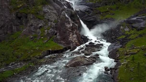 Waterfall in mountains of Norway in rainy weather from air view from drone — Stock Video