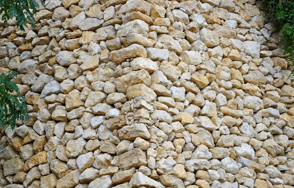 The angle of the wall is constructed of river stones with ivy growing on it