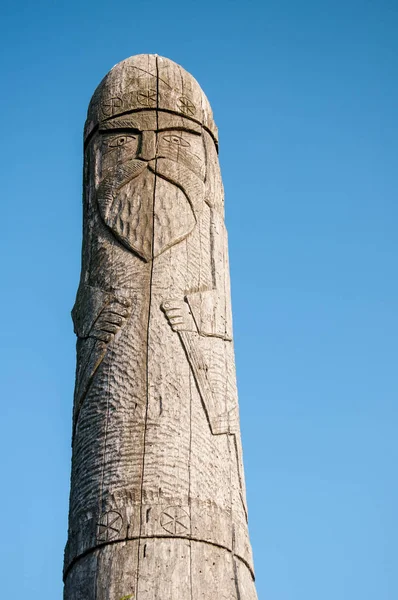 Wooden idol Slavic god Perun on a background of blue sky