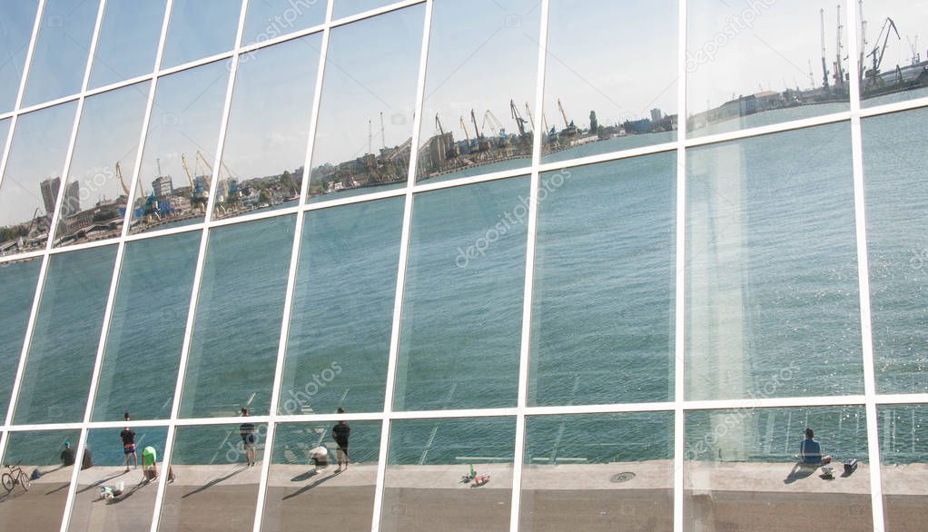Seaport Reflection in glass wall of a modern building