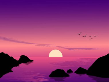 Sahilde gün batımı kayalarla