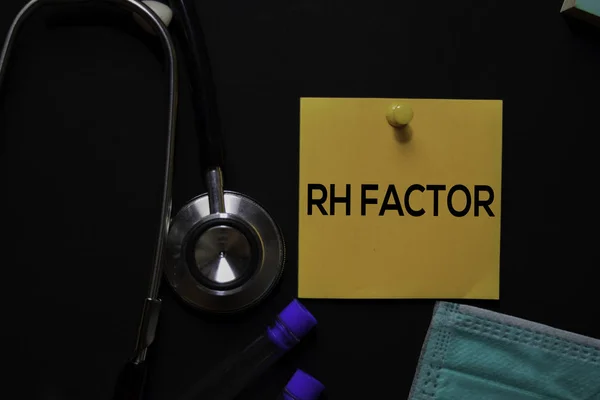 RH Factor text on sticky notes. Office desk background. Medical or Healthcare concept