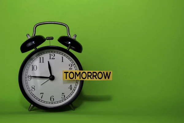 Tomorrow write on sticky note isolated green background. Procrastination or delay concept — Stock Photo, Image