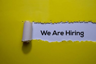 We Are Hiring Text written in torn paper