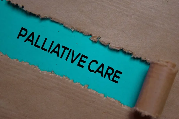 Palliative Care Text written in torn paper. Medical concept