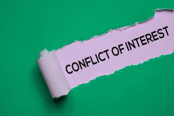 Conflict of Interest Text written in torn paper