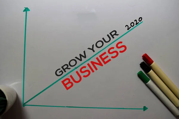 Grow Your Business 2020 write on white board background. Chart or mechanism concept