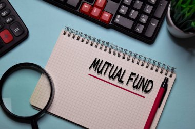 Mutual Fund write on a book isolated on office desk.
