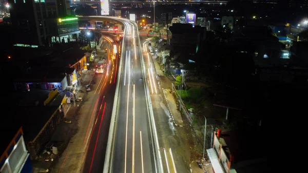 Trilhas de luz na auto-estrada à noite, exposição longa abstrato fundo urbano em Bekasi — Fotografia de Stock